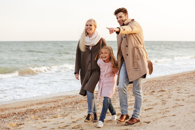 Portrait of a happy family with a little daughter