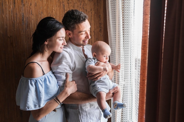 Portrait of happy family with their baby