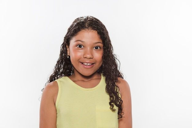 Portrait of happy girl against white backdrop