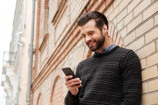 Free photo portrait of a happy handsome man in sweater