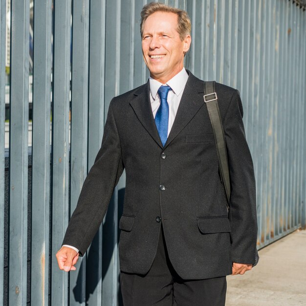 Portrait of a happy mature businessman in black suit