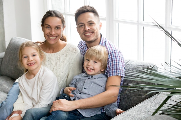 Free photo portrait of happy multi-ethnic family embracing adopted kids bonding together