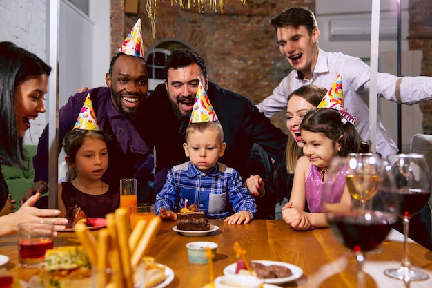 Portrait of happy multiethnic family celebrating a birthday at home