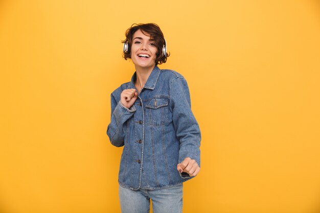 Portrait of a happy positive woman dressed in denim jacket