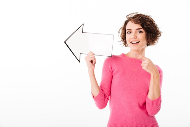 Free photo portrait of a happy pretty girl pointing away