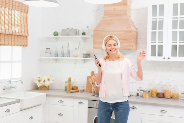 Free Photo portrait of happy senior woman with headphones