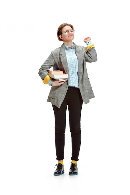 Free photo portrait of a happy smiling female student holding books isolated on white wall