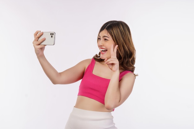 Free photo portrait of happy smiling young woman selfie with smartphone isolated over white background