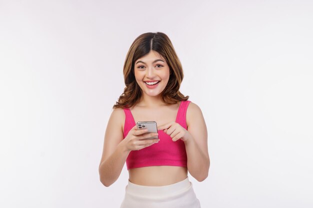 Portrait of happy smiling young woman using mobile phone isolated over white background