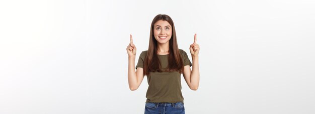 Portrait happy and surprised young lady standing isolated over grey background looking camera pointi