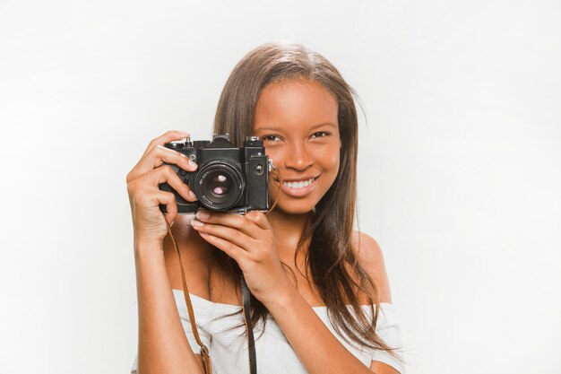 Portrait of a happy teenage girl with dslr camera