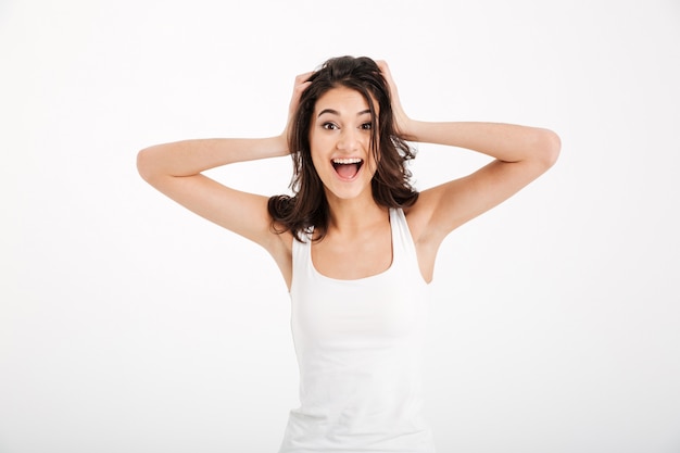 Portrait of a happy woman dressed in tank-top screaming