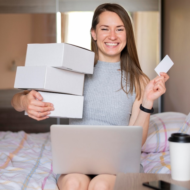 Free photo portrait of happy woman holding shopping boxes