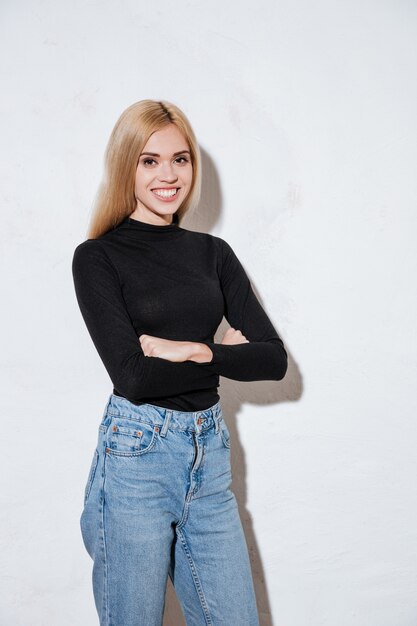 Portrait of a happy woman standing with arms folded