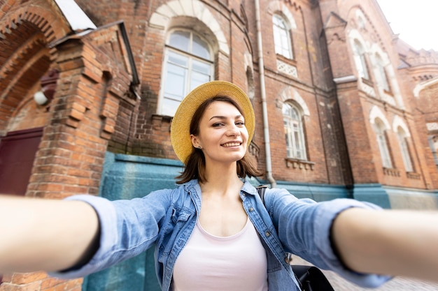 Free Photo portrait of happy woman taking a selfie outdoors