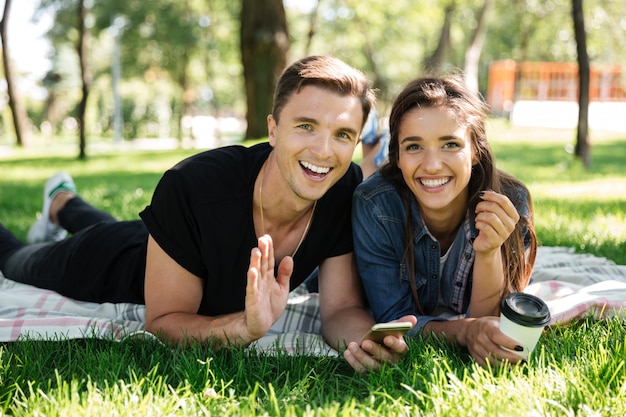 Portrait of happy young couple drinking coffee