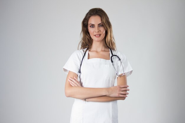 Portrait of happy young doctor woman standing ,isolated on white background.