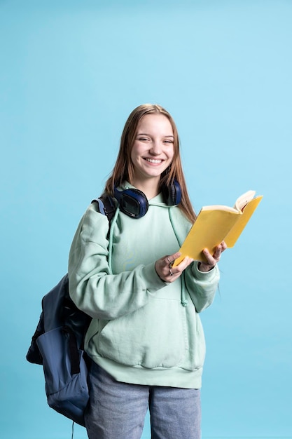 Free Photo portrait of happy young girl smiling while reading book