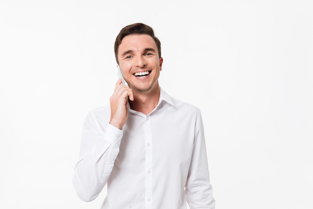 Portrait of a happy young man in a white shirt