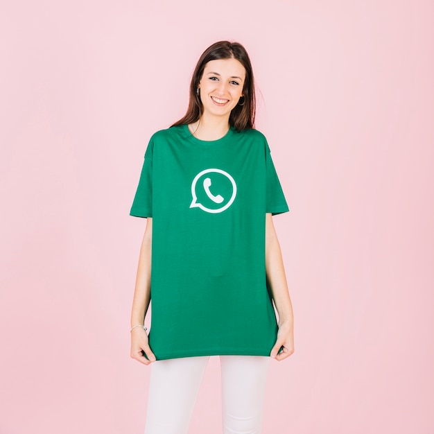 Free photo portrait of a happy young woman in green whatsapp t-shirt