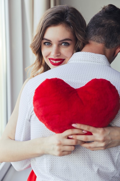 Free Photo portrait of a happy young woman holding her boyfriend