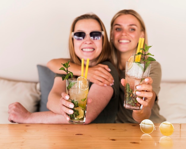 Free Photo portrait of happy young women enjoying drinks