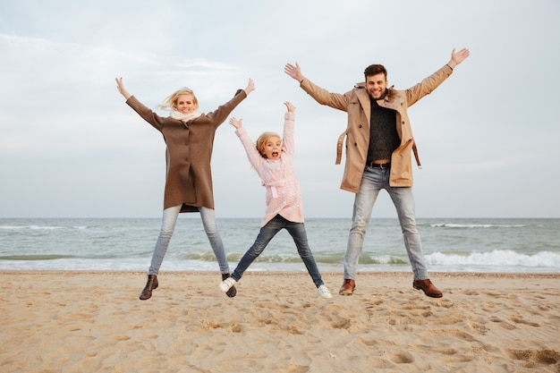 Portrait of a joyful family with a little daughter