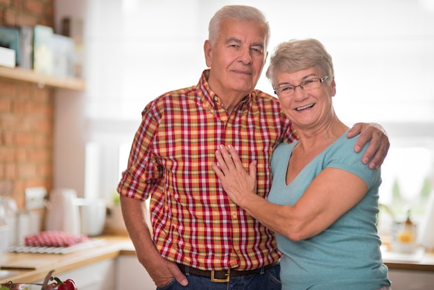 Portrait of joyful senior couple in the kitchen