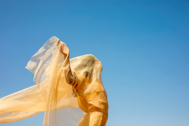 Free photo portrait of joyful woman with yellow cloth in nature