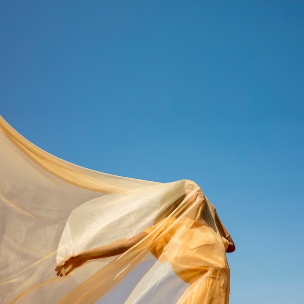 Free photo portrait of joyful woman with yellow cloth in nature