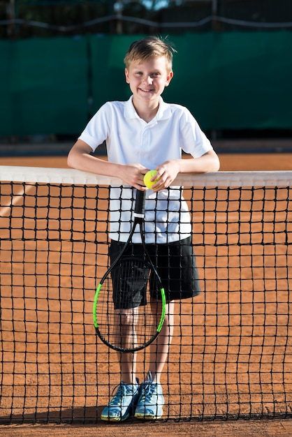 Portrait of kid on the tennis field