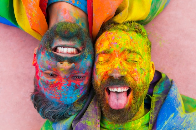 Free Photo portrait of laughing gay pair soiled in paint