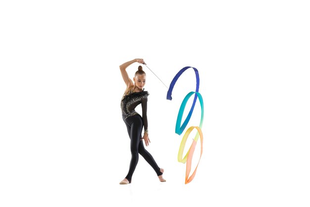 Portrait of little girl, rhythmic gymnastics artist training isolated on white