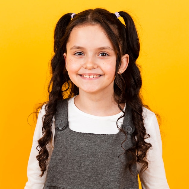 Portrait little girl smiling with pigtails hair