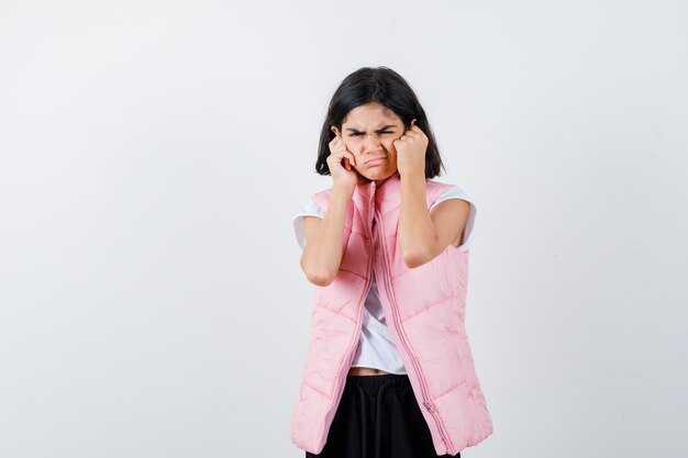 Portrait of a little girl in white t-shirt and puffer vest