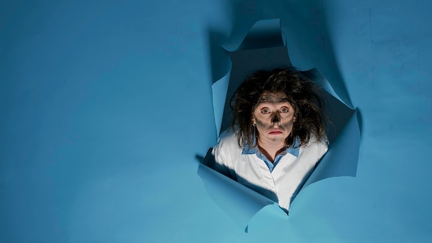 Free Photo portrait of mad crazy chemist with messy hair after scientific explosion, making goofy facial expressions in studio. silly foolish scientist having funny explosive hairstyle, fun woman.