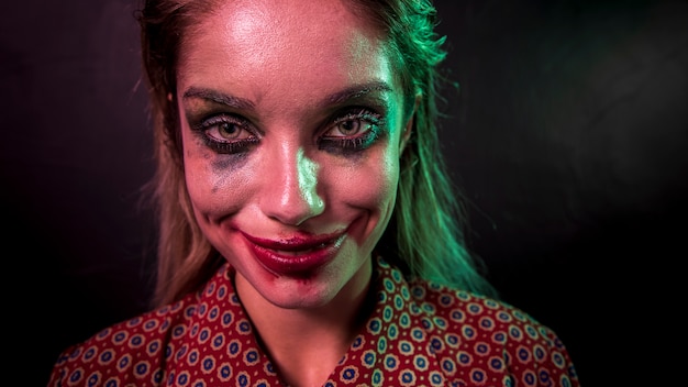 Portrait of a make-up clown horror character looking at camera