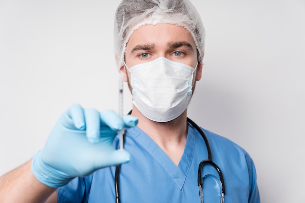 Free Photo portrait of male nurse holding syringe