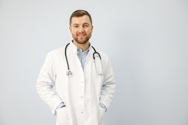 Portrait of a male physician looking at camera isolated on white background