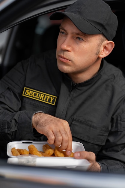 Portrait of male security guard having a lunch break