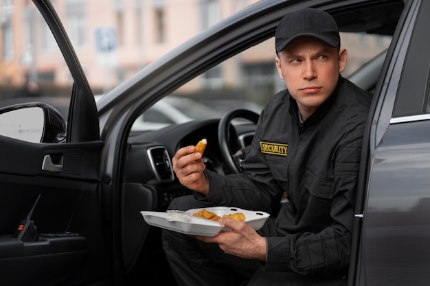 Portrait of male security guard having a lunch break