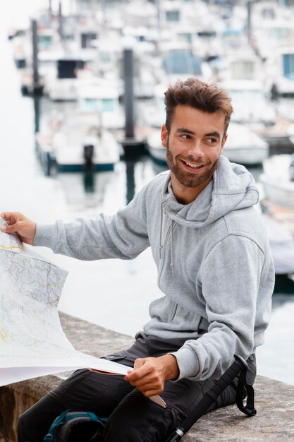 Portrait of male traveler checking a map