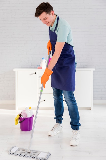 Portrait of man cleaning his house