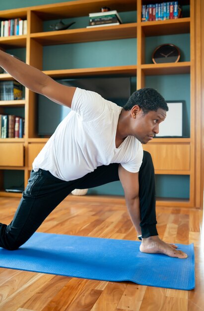 Portrait of a man doing exercise while staying at home