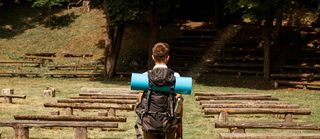 Portrait man exploring park with benches