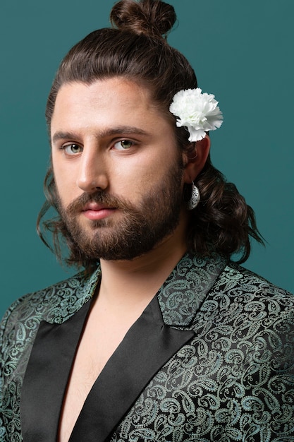 Free Photo portrait man in fashionable clothes holding flowers in hair