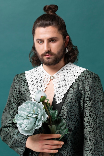 Free photo portrait man in fashionable clothes holding flowers