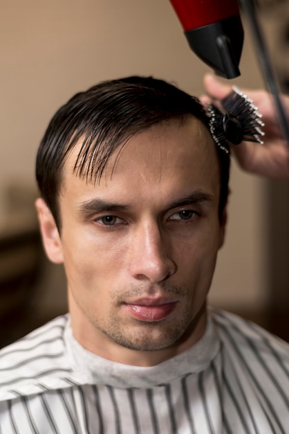 Portrait of a man getting a haircut