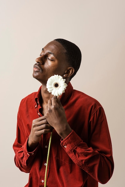 Portrait of man holding flower