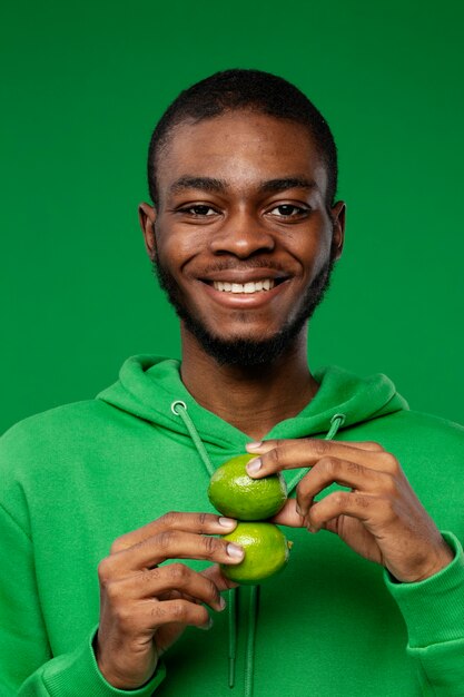 Portrait of man holding lime citrus